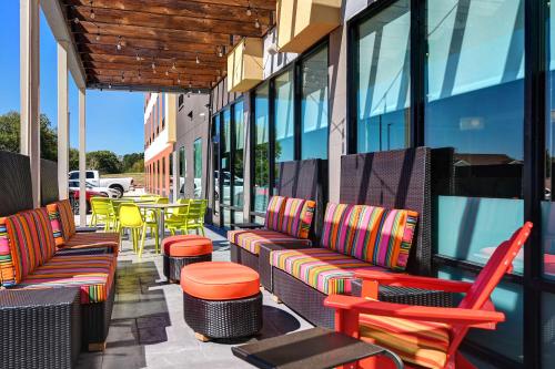 a row of chairs and tables on a patio at Home2 Suites by Hilton North Plano Hwy 75 in Plano