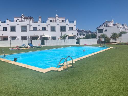 a large swimming pool in front of a large building at Casa Mimi - your perfect family getaway in Corralejo