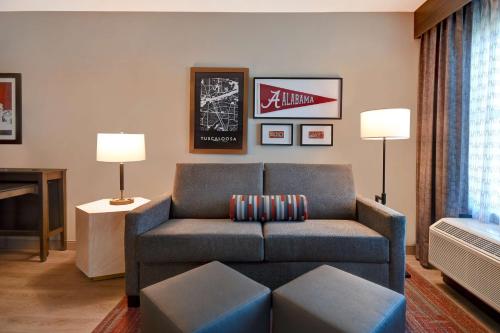 a living room with a couch and a table at Homewood Suites by Hilton Tuscaloosa Downtown- Near Univ of Alabama in Tuscaloosa
