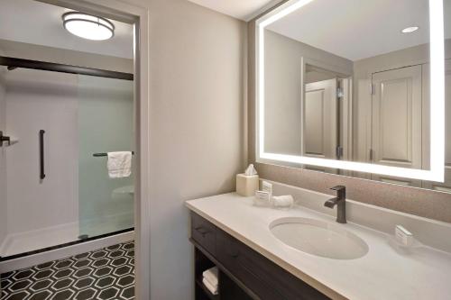 a bathroom with a sink and a mirror at Homewood Suites by Hilton Tuscaloosa Downtown- Near Univ of Alabama in Tuscaloosa
