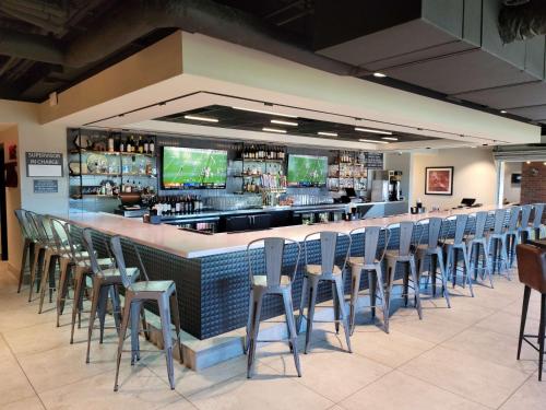 a bar with a row of chairs in a restaurant at Homewood Suites by Hilton Tuscaloosa Downtown- Near Univ of Alabama in Tuscaloosa