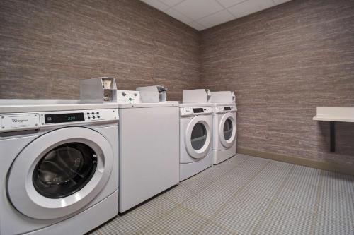 a laundry room with a washer and dryer at Homewood Suites by Hilton Tuscaloosa Downtown- Near Univ of Alabama in Tuscaloosa