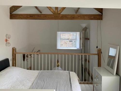 a bedroom with a bed and a television in it at Stunning Barn, Bowes, Barnard Castle in Barnard Castle