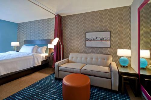 a hotel room with a bed and a couch at Home2 Suites By Hilton Bowling Green, Oh in Bowling Green