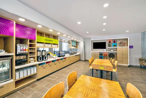 a restaurant with tables and chairs in a store at Home2 Suites by Hilton Minneapolis Downtown in Minneapolis