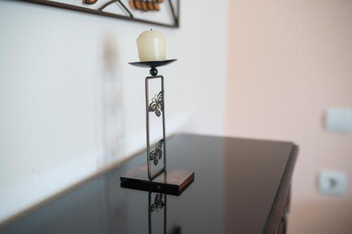 a candle on a stand in a room at Pigeon House in Plataria