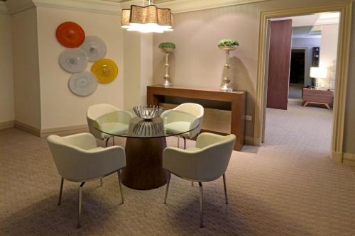 a dining room with a table and chairs at MS Milenium Monterrey Curio Collection by Hilton in Monterrey