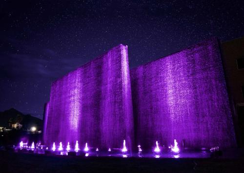a building with purple lights on it at night at MS Milenium Monterrey Curio Collection by Hilton in Monterrey