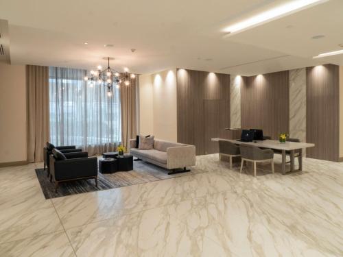 a living room with a couch and a table at MS Milenium Monterrey Curio Collection by Hilton in Monterrey