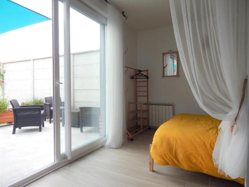 a bedroom with a bed and a sliding glass door at Miss Tine 