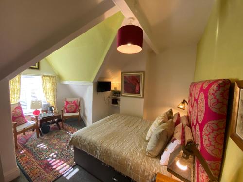 a bedroom with a bed and a living room at The Mayfield Boutique Guest House in Blackpool