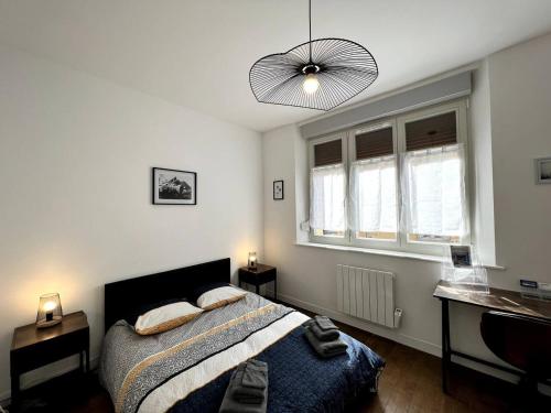1 dormitorio con cama, escritorio y lámpara en Appartement Turquoise - 2 pers - Sedan, en Sedan