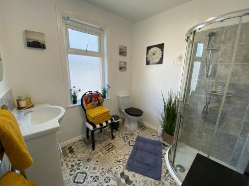 a bathroom with a shower and a sink at The Mayfield Boutique Guest House in Blackpool