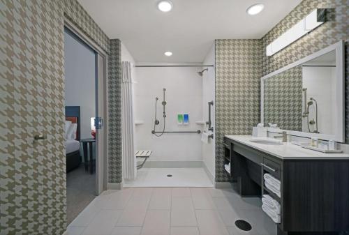 a bathroom with a sink and a large mirror at Home2 Suites By Hilton Salem in Salem