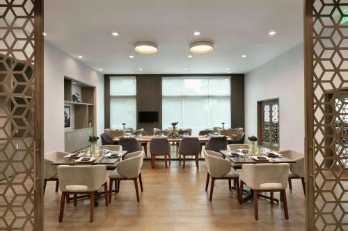 a dining room with a large table and chairs at Embassy Suites by Hilton Atlanta Midtown in Atlanta