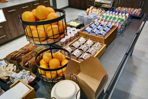 a display of oranges in baskets on a counter in a store at Hampton Inn Cave City, KY in Cave City