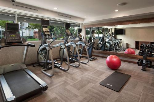 a gym with a row of treadmills and exercise bikes at Redondo Beach Hotel, Tapestry Collection by Hilton in Redondo Beach