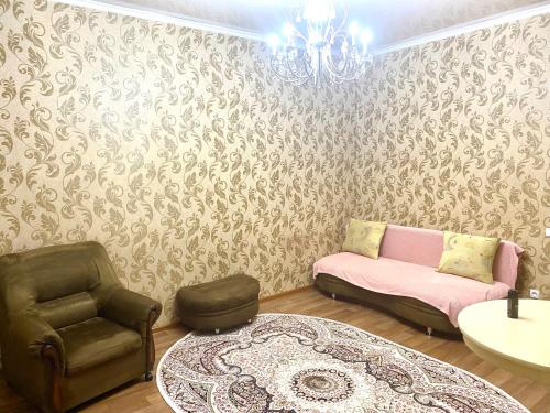 a living room with a couch and a chair at Майлина 10 аэропорт in (( Turksib ))