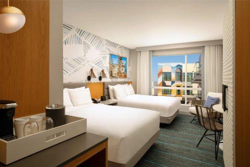 a hotel room with two beds and a window at The Monsaraz San Diego, Tapestry Collection By Hilton in San Diego