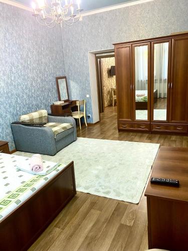 a living room with a couch and a rug at Майлина 10 аэропорт in (( Turksib ))