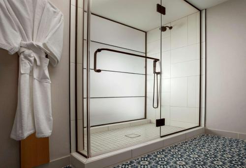 a shower with a glass door in a bathroom at The Monsaraz San Diego, Tapestry Collection By Hilton in San Diego