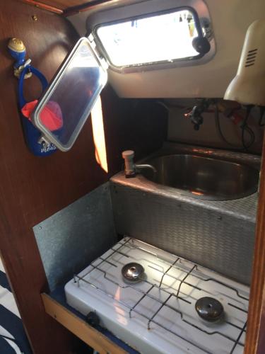 a small kitchen in an rv with a sink at Petit voilier à quai Port Barcares in Le Barcarès
