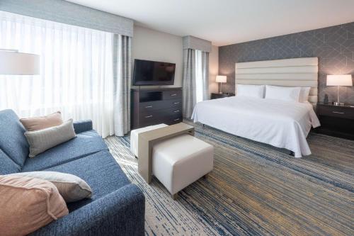 a hotel room with a bed and a couch at Homewood Suites By Hilton Sunnyvale-Silicon Valley, Ca in Sunnyvale