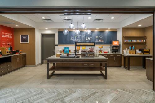a lobby of a store with a table in the middle at Hampton Inn Hardeeville, Sc in Hardeeville