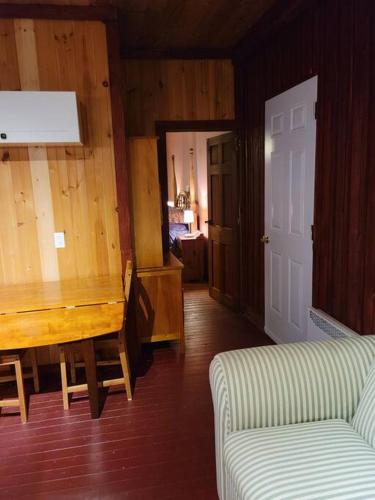 a living room with a wooden table and a couch at appartement, loft in Sainte-Rose-du-Nord