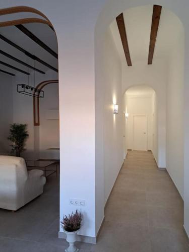 a hallway with a white room with a white couch at Casa vacacional El Sol in Turís