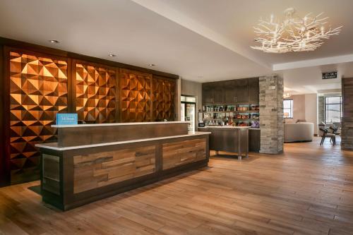 a restaurant with a counter with wine bottles at Homewood Suites By Hilton Dillon in Dillon