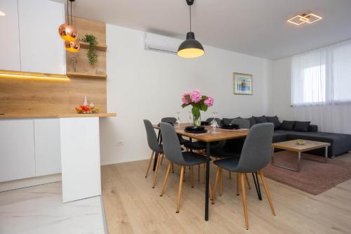 a dining room and living room with a table and chairs at Miranda's Place in Split