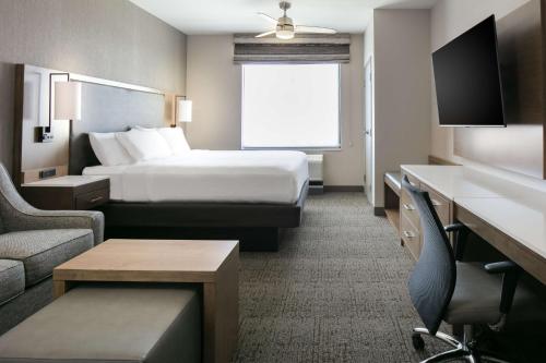 a hotel room with a bed and a tv at Homewood Suites By Hilton Dillon in Dillon