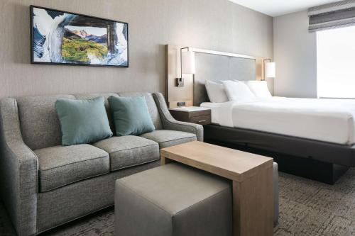 a hotel room with a couch and a bed at Homewood Suites By Hilton Dillon in Dillon