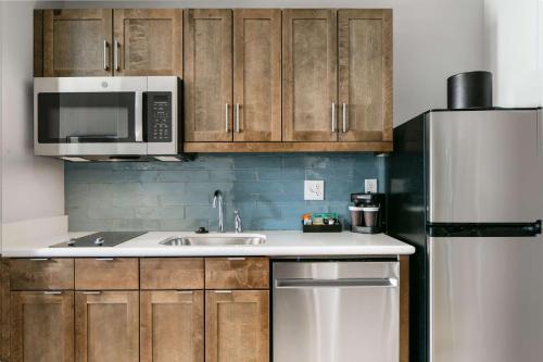a kitchen with a sink and a microwave and a refrigerator at Homewood Suites By Hilton Dillon in Dillon