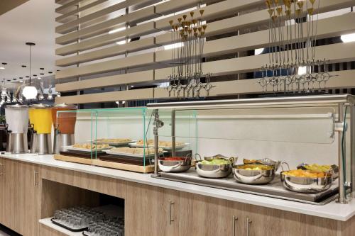 a buffet line with many pans of food at Embassy Suites by Hilton Round Rock in Round Rock