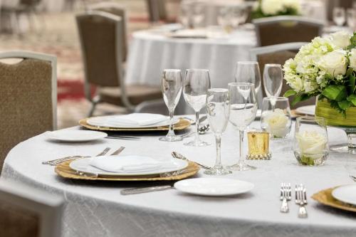 a table with plates and wine glasses on it at Embassy Suites by Hilton Round Rock in Round Rock