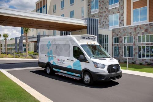 a white van parked in front of a building at Hilton Garden Inn Panama City Airport, Fl in Panama City