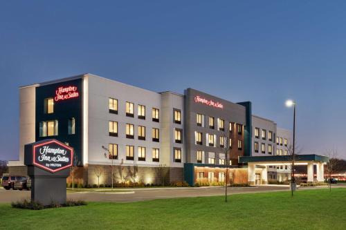 a large building with a sign in front of it at Hampton Inn & Suites Olean, Ny in Olean