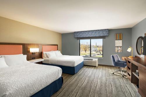 a hotel room with two beds and a desk at Hampton Inn & Suites Olean, Ny in Olean