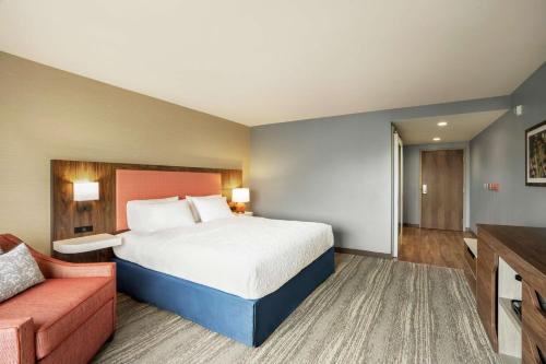 a hotel room with a bed and a couch at Hampton Inn & Suites Olean, Ny in Olean