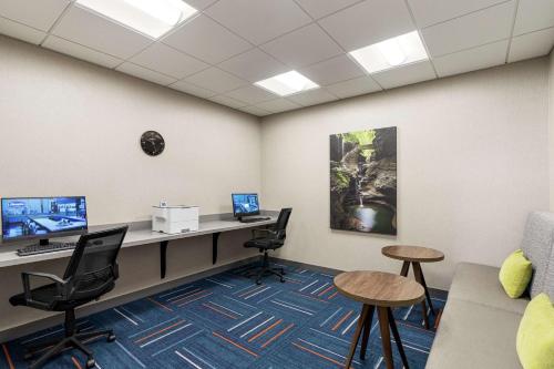 an office with a desk with two computers and chairs at Hampton Inn & Suites Olean, Ny in Olean