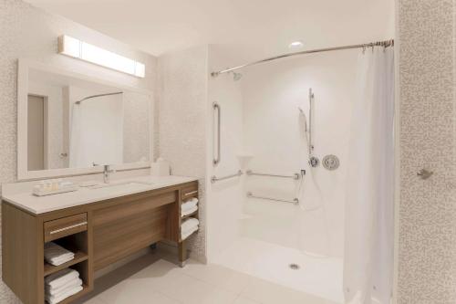 a white bathroom with a sink and a shower at Home2 Suites By Hilton West Sacramento, Ca in West Sacramento