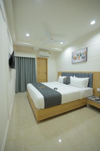 a bedroom with a large bed in a room at Hotel Shayan Inn in Rajkot