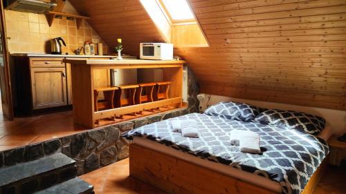 a bedroom with a bed in a wooden cabin at ROYAL GARDEN APARTMENTS *** in Štítary