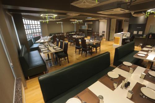 an overhead view of a restaurant with tables and chairs at Hotel Shayan Inn in Rajkot