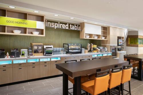 a fast food restaurant with a table and chairs at Home2 Suites By Hilton Phoenix Avondale, Az in Avondale