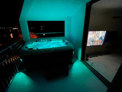 a bathroom with a tub and a tv in a room at villa Ana in Preko