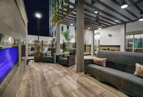 a lobby with couches and a large screen tv at Home2 Suites by Hilton Houston Medical Center, TX in Houston