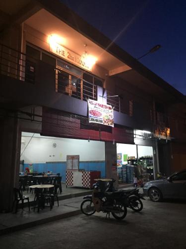a motorcycle parked in front of a building at night at The Second Room in Ranau